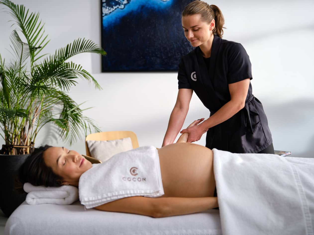 Massage therapist attending to a pregnant woman