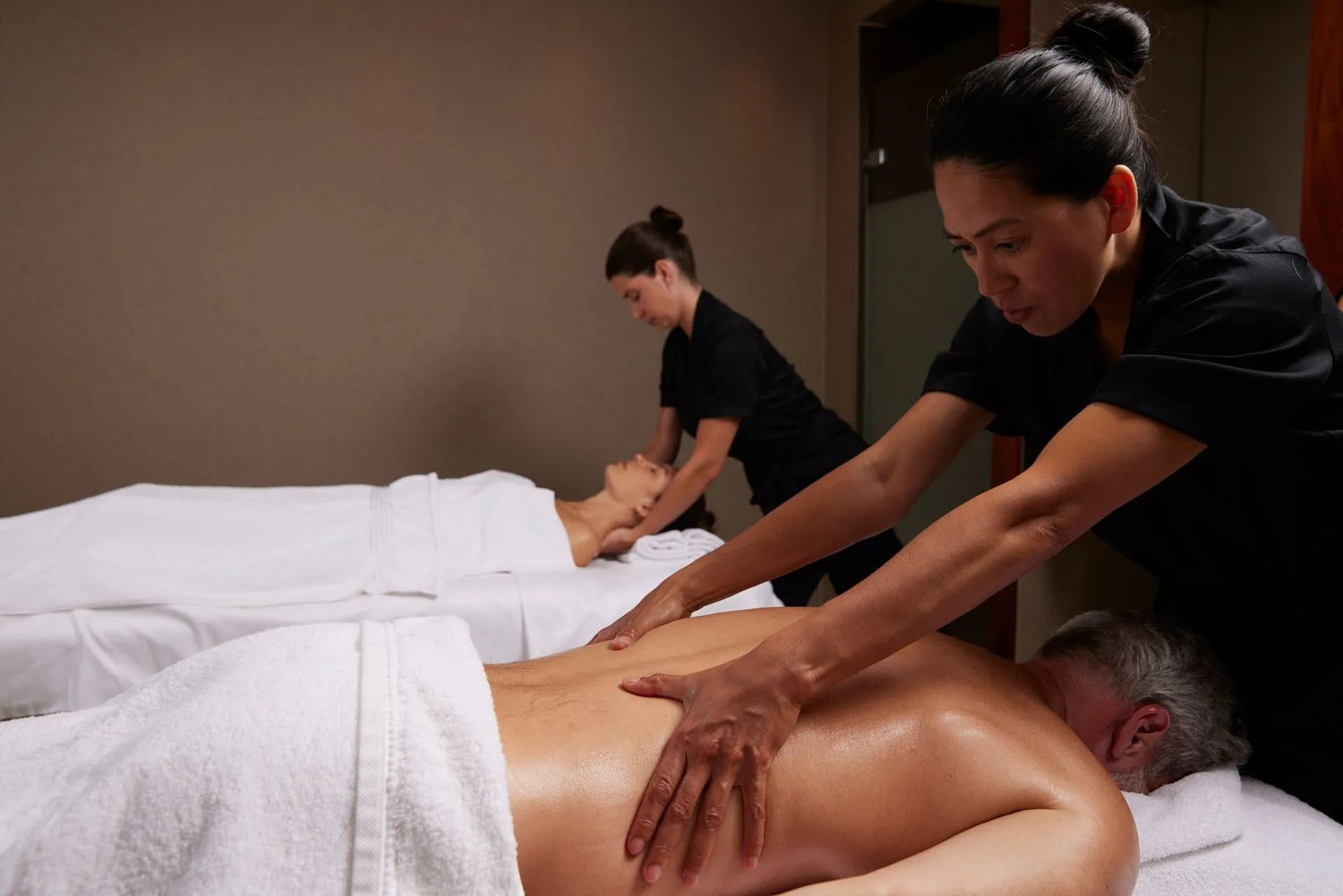 Elite COCON Group spa therapists delivering a premium deep tissue massage treatment at Nagomi Spa, Hotel Okura Amsterdam.