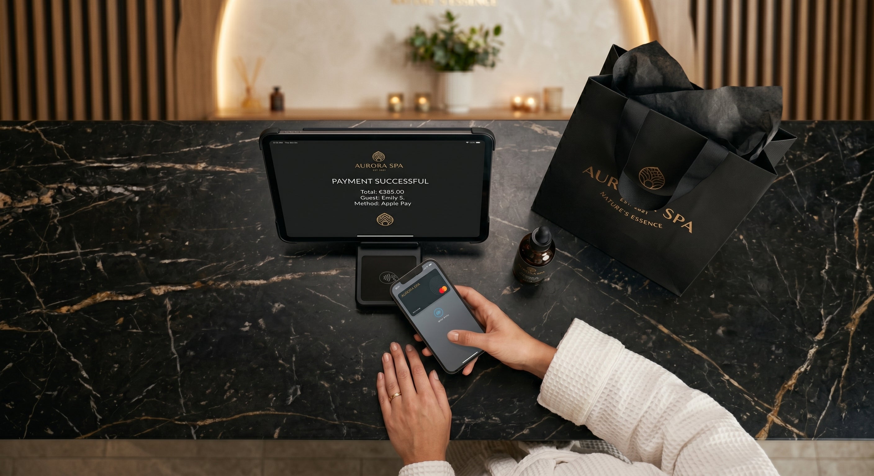 Hotel guest at a luxury spa reception desk utilizing digital yield management technology and commercial booking systems implemented by COCON Group to drive RevPAR.
